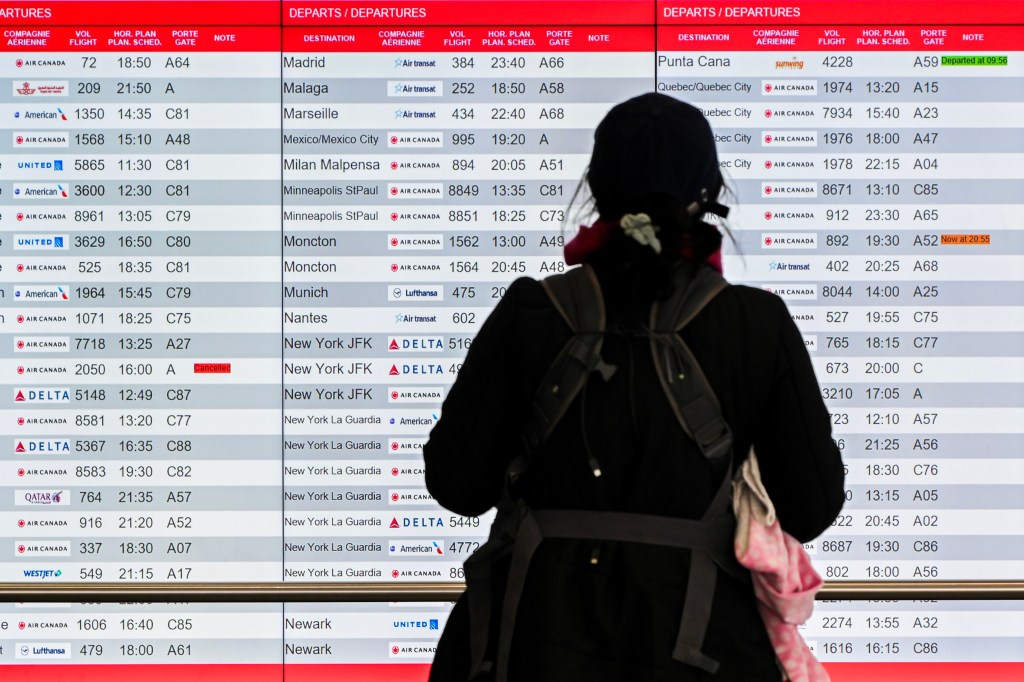 A passenger looking at the flight display.